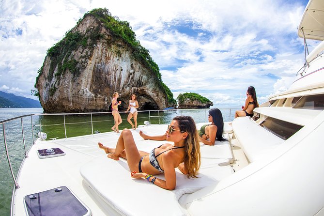 boat cruising past Puerto Vallarta’s coastline with blue water and jungle mountains.