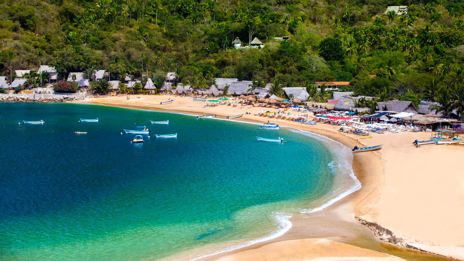 photo of Yelapa Beach with colorful boats and palm trees.