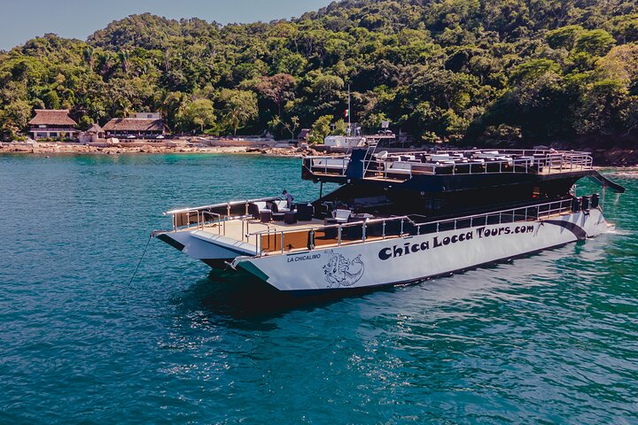 Yacht anchored near the hidden beach of Yelapa with lush jungle views.