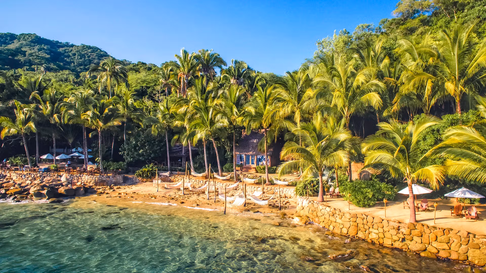 photo of Las Caletas Beach with lush jungle and white sand.