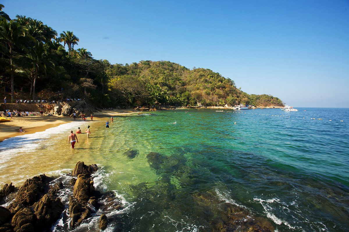 photo of Las Caletas with hammocks and clear blue water.
